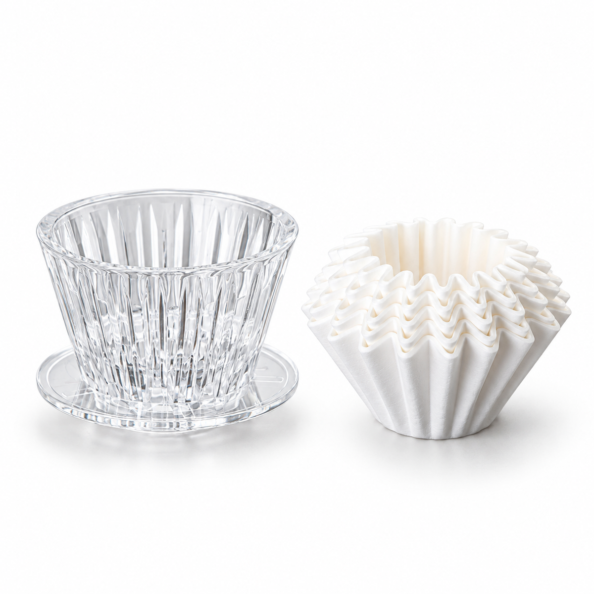 Clear PC pour-over dripper with 50 white paper filters on a white background