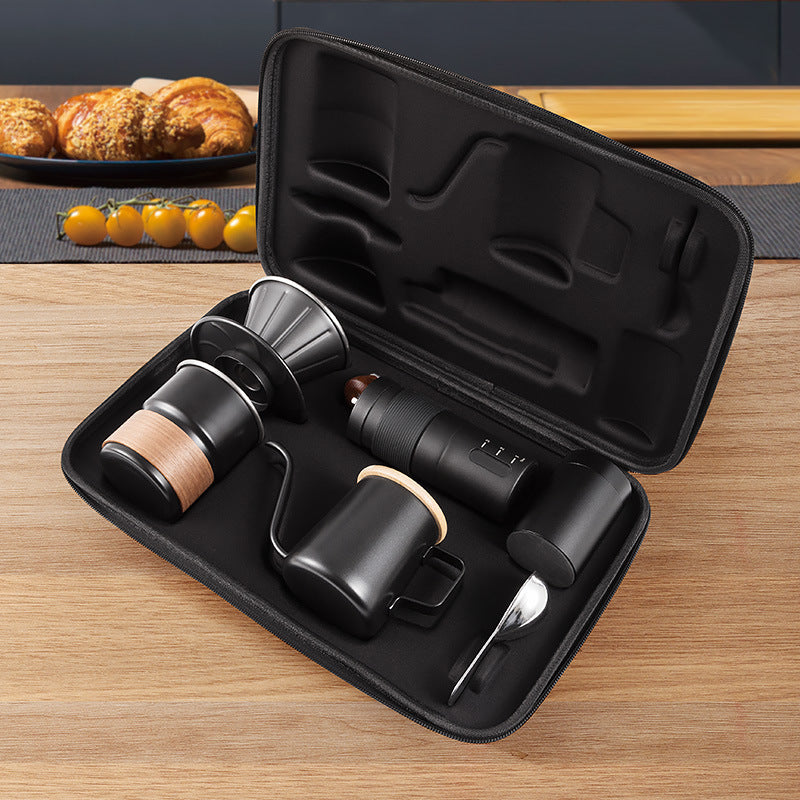 Open carrying case holding the black pour-over kit on a wooden counter