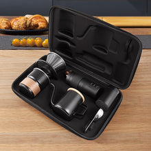 Open carrying case holding the black pour-over kit on a wooden counter
