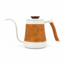 White gooseneck kettle with a brown leather body sleeve and handle wrap