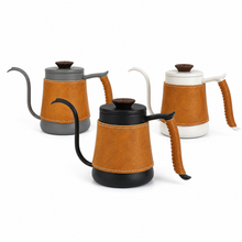 Grey, black and white gooseneck kettles with brown leather sleeves